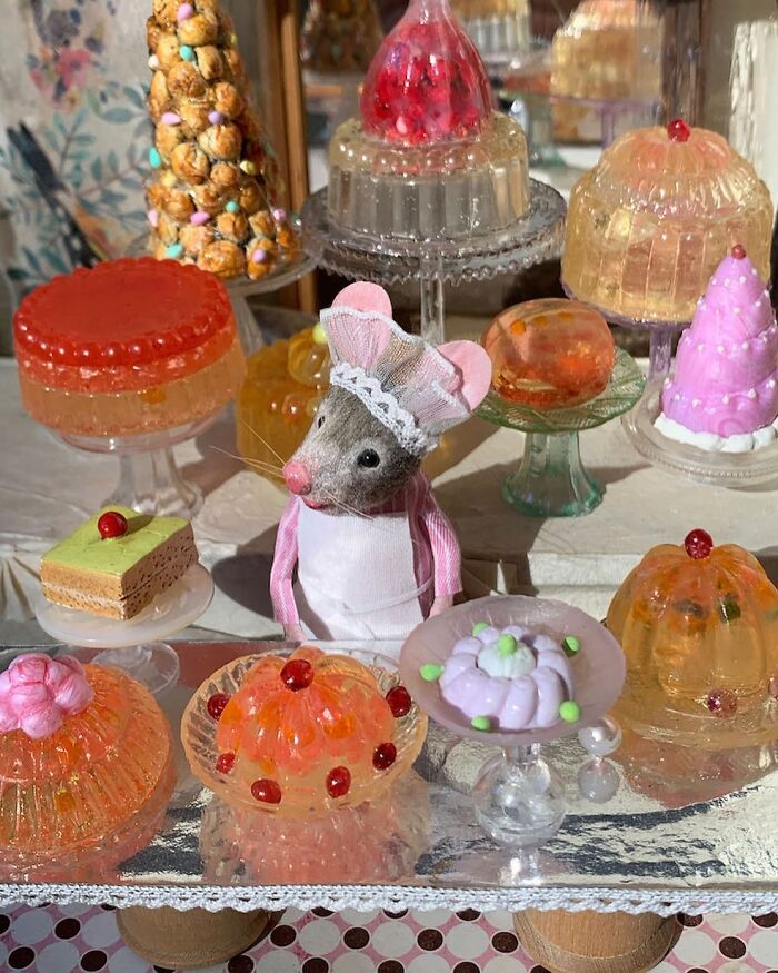 Miniature world of Mouseland featuring a mouse in a pink apron surrounded by detailed colorful gelatin desserts.