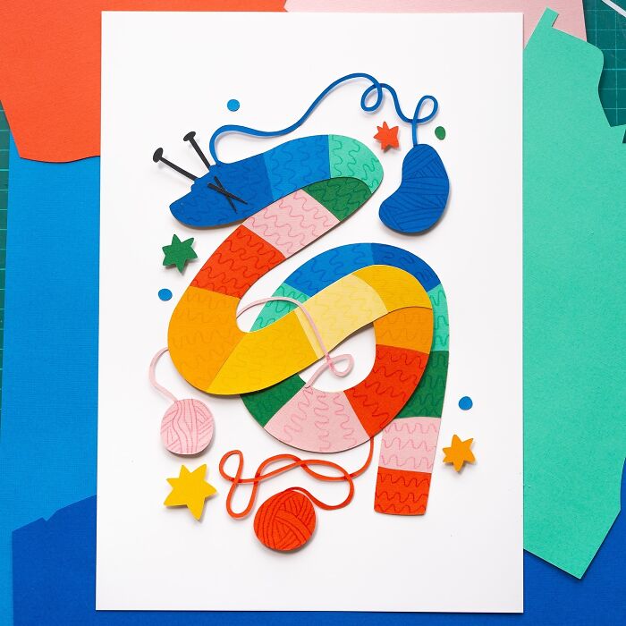 Layered paper snake illustration with colorful yarn and stars.