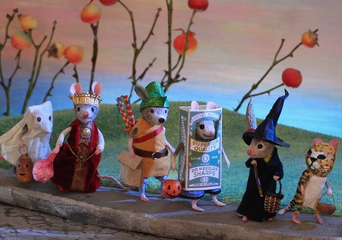 Miniature mice in costumes, part of Maggie Rudy's detailed Mouseland world, set against a whimsical backdrop.