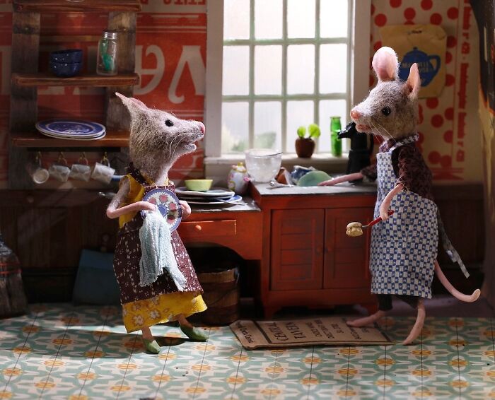 Miniature mice in aprons washing dishes in a detailed kitchen setting, part of Maggie Rudy's Mouseland.