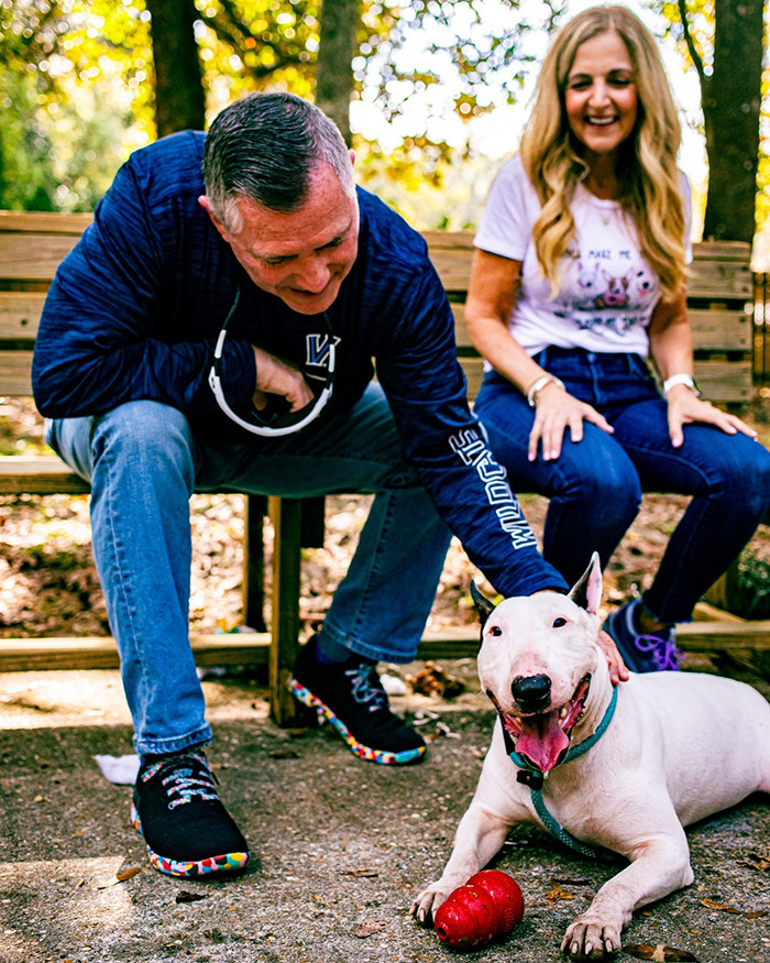 Dog Trooper plays joyfully with new owners after Hurricane Milton rescue.