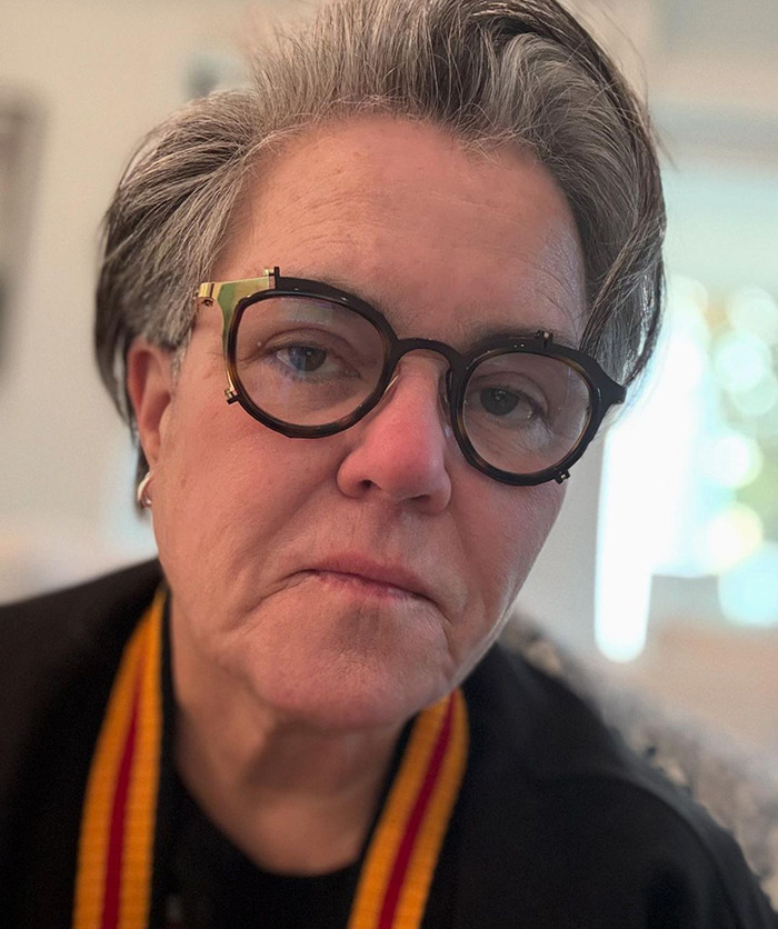 Rosie O'Donnell wearing glasses and black top.