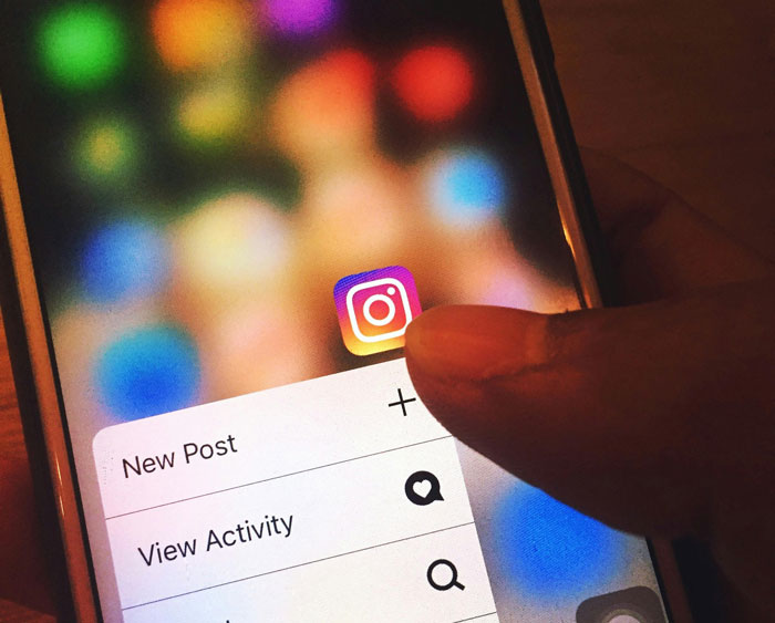 Person browsing Instagram app on a smartphone, highlighting security measures online.