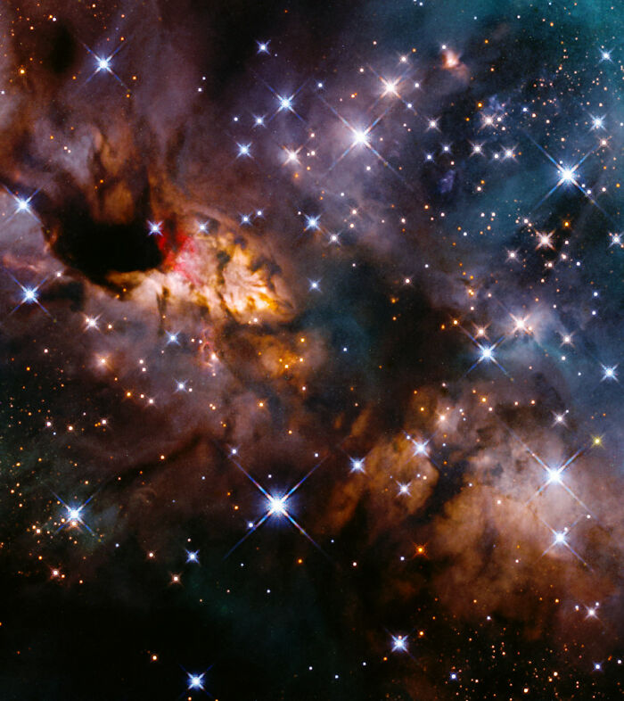 Colorful nebula with stars shining brightly against a dark cosmic backdrop.