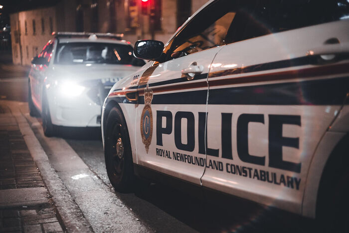 Police cars on city street at night, potential worst things that happen during wedding events.