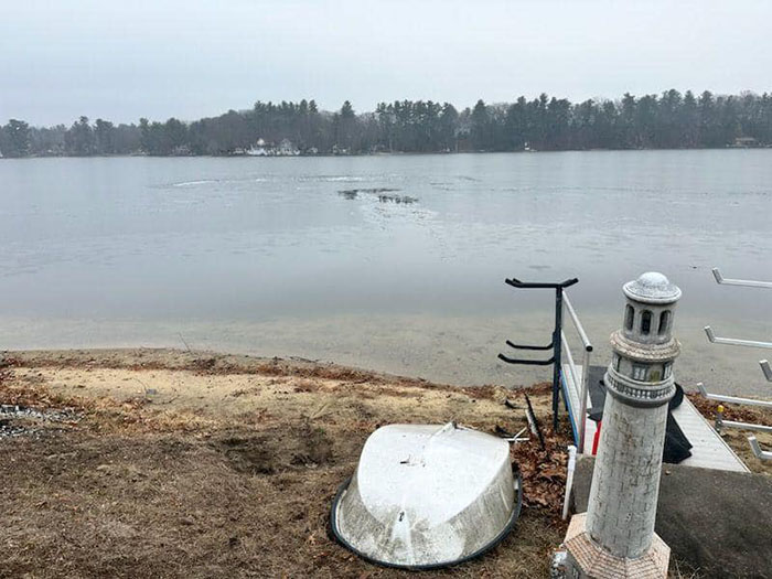 Frozen lake with an ice chunk near a snowy shore, highlighting a rescue scenario involving a blind cat.