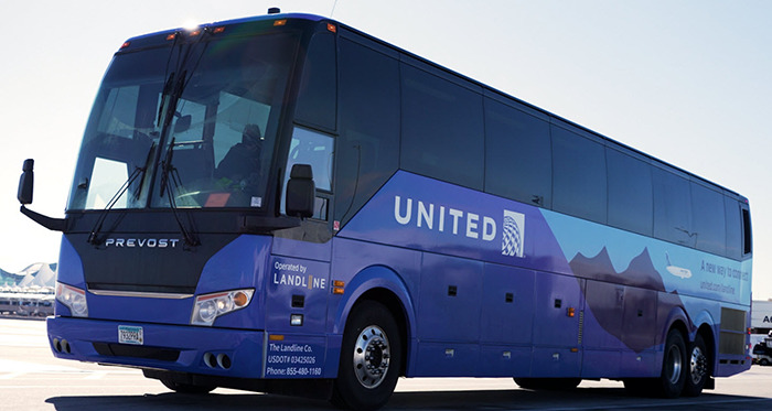 United bus at airport with mountains painted on side, related to wedding photographer and family incident.