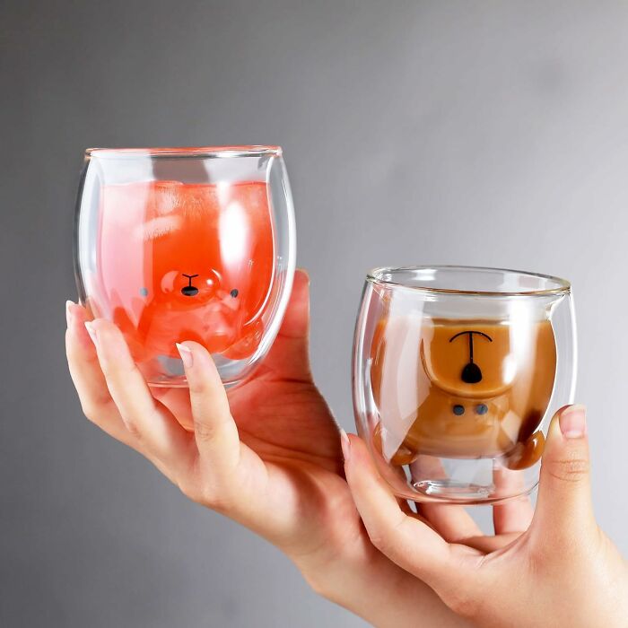 Hand holding novelty bear-shaped glass cups, showcasing coolest design feature for trendy drinkware enthusiasts.