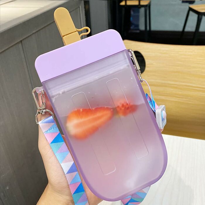 Trendy water pouch with purple lid and colorful strap, filled with water and strawberry slices, representing coolest things.