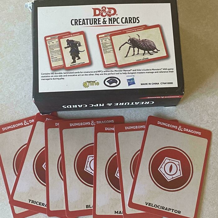 D&D Creature cards with misleading packaging displaying Velociraptor, Triceratops options.