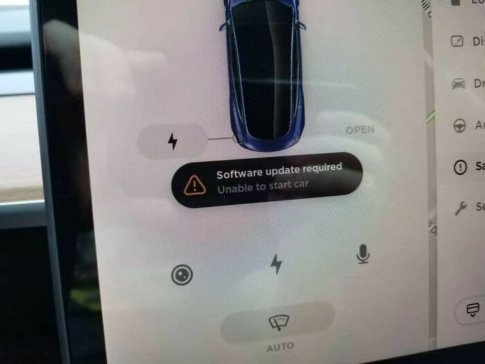 Dashboard screen showing "Software update required" error, a deceptive-marketing-techniques reminder in automotive tech.