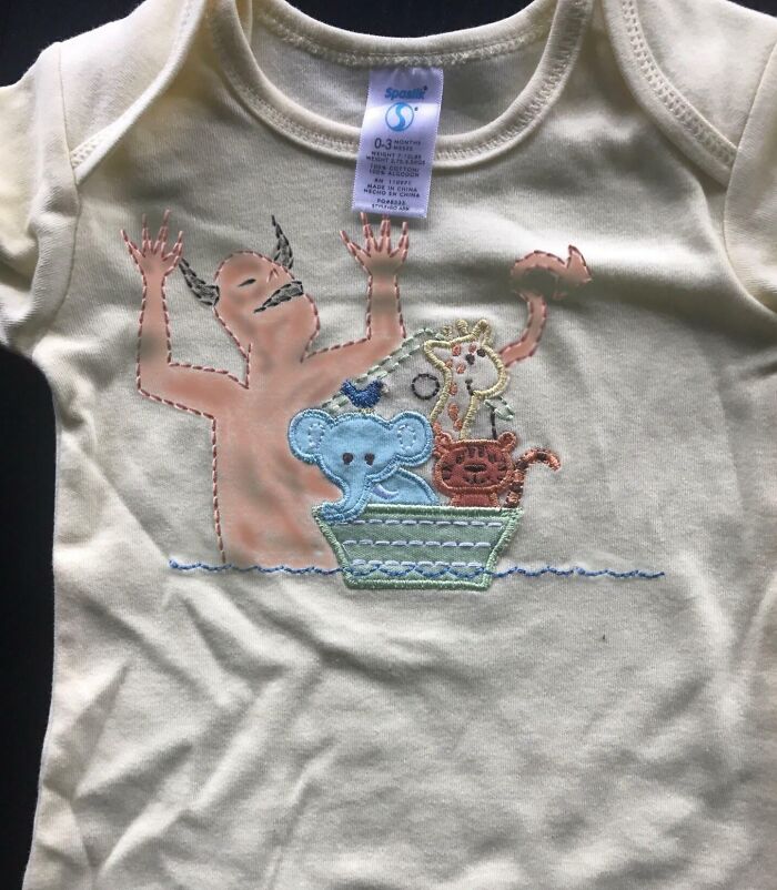 Baby onesie with a funny in-law themed cartoon featuring animals in a boat and a joyful figure.