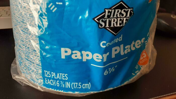 Misleading packaging showing a stack of 125 paper plates labeled First Street, appearing larger than actual size.