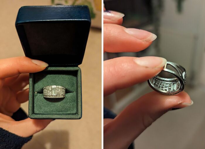 A person holds a diamond ring, a unique inheritance, displaying it in a black box and from the side.