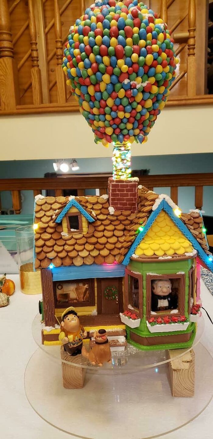 Gingerbread house with colorful candy balloon, a beautiful food creation sure to captivate foodies.