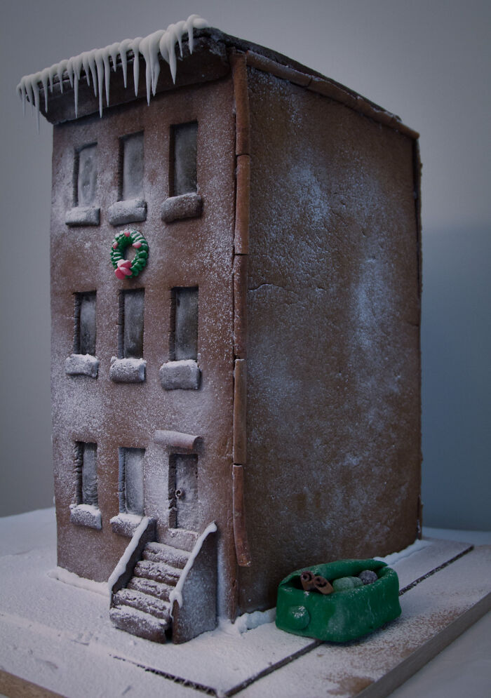 Edible gingerbread building with realistic details, designed for foodies to admire and love, featuring icing icicles.