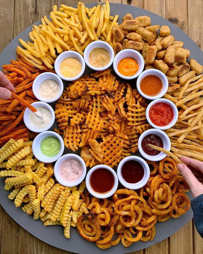 Beautiful assorted fries and dipping sauces arranged on a platter, perfect for foodies to love and enjoy.