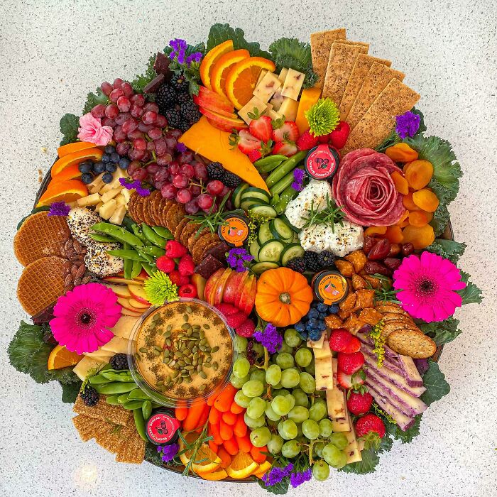 Beautiful food pic featuring a vibrant charcuterie board with fruits, cheese, crackers, and colorful garnishes.