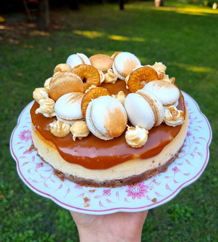 Delicious cheesecake topped with macarons and caramel, perfect for foodies to love.