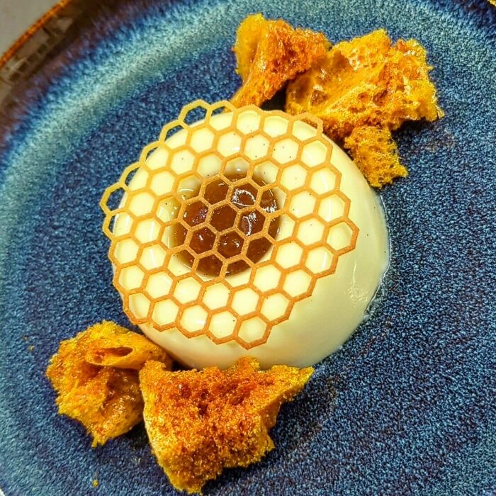 Elegant dessert with honeycomb decor and caramelized pieces, a beautiful food creation sure to captivate foodies.