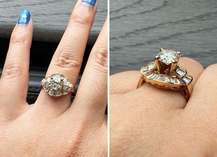 Gold diamond ring, a unique inheritance, showcased on a hand with blue nails against a neutral background.