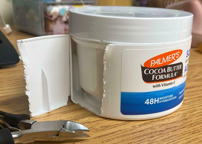 Misleading packaging design of a cream container with false interior size.