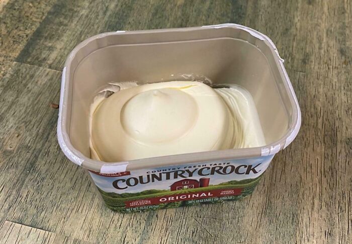 Misleading packaging example showing a Country Crock container half-filled with margarine.