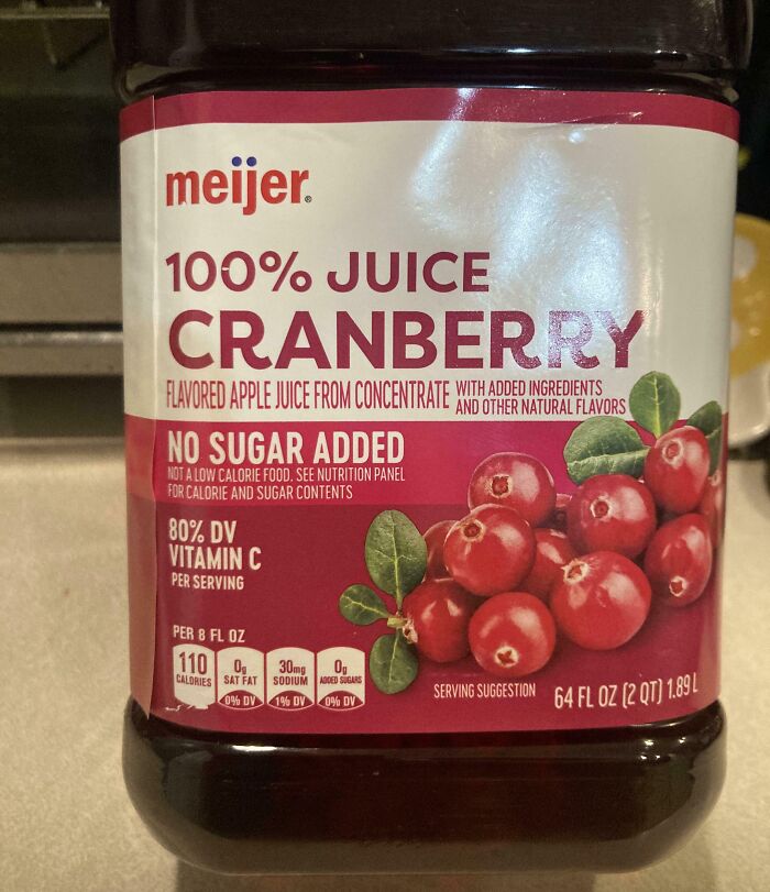 Cranberry juice bottle with misleading packaging, highlighting "100% juice" but notes added apple juice and other flavors.