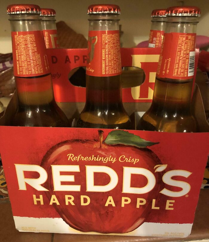 Six-pack of Redd's Hard Apple in packaging that suggests apple flavor but contains beer. Misleading packaging design example.