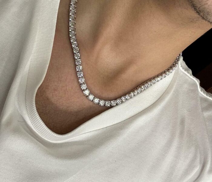 Diamond necklace worn over a white shirt, representing a unique inheritance.