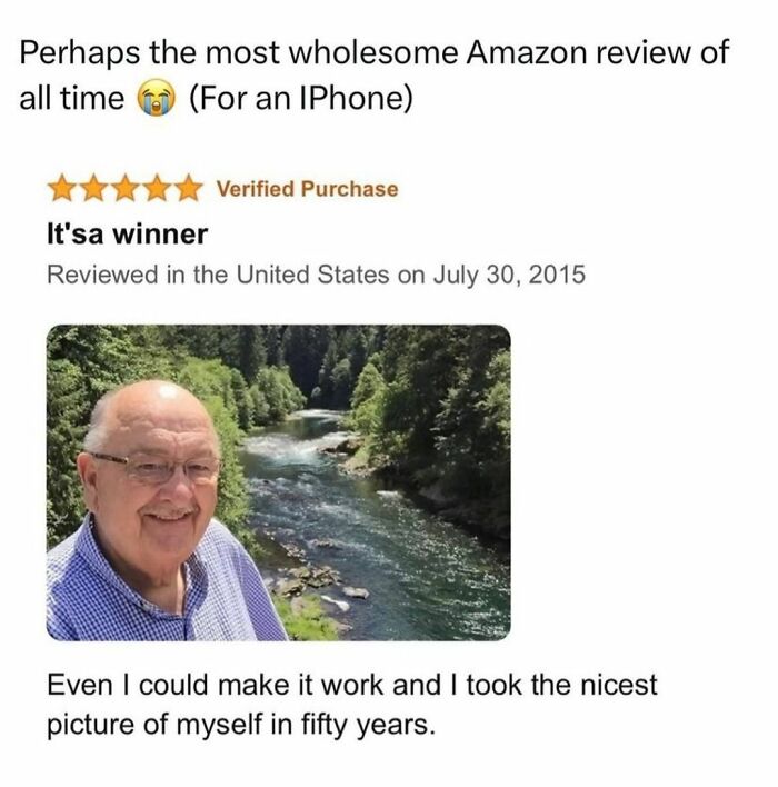 Man smiling in a forest with river, sharing a wholesome Amazon review of an iPhone, enjoying random memes.