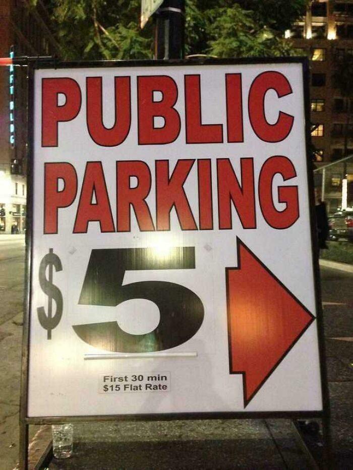 Sign with deceptive-marketing-techniques, stating $5 parking with smaller print revealing $15 flat rate.