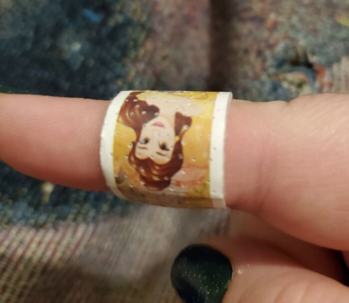 Cartoon band-aid on a person's finger, humorously related to good-funny-bosses.