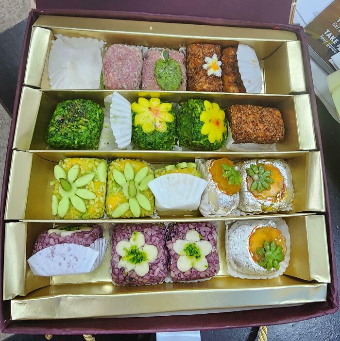 A colorful assortment of decorated sweets in a gift box, perfect for sharing with funny bosses.