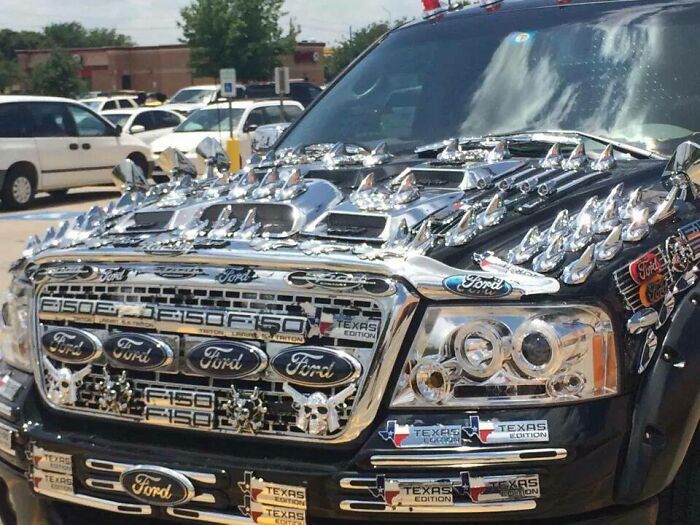 Car covered in excessive chrome badges and ornaments, showcasing a humorous example of car-fails.