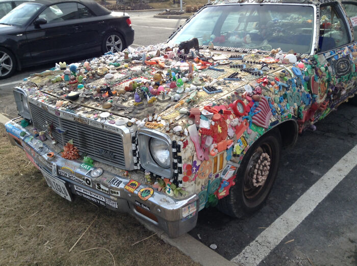 Decorated car covered in toys and trinkets exemplifying car-fails with a unique, cluttered design.