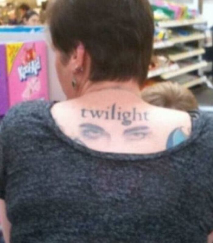 Back tattoo reading 'twilight' with eyes, illustrating an epic tattoo fail.