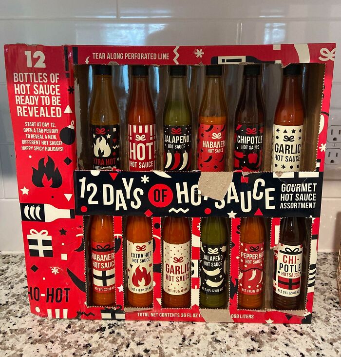 Hot sauce packaging showing 12 bottles with various flavors, highlighting playful design with hints of marketing exaggeration.