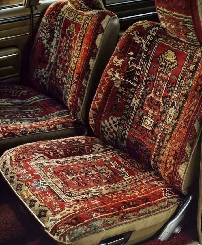 Car seats covered in ornate, multi-colored rug fabric, showcasing a humorous car-fails upholstery choice.