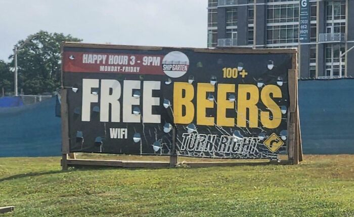 Billboard with "Free Beers" in large letters, an example of deceptive marketing techniques.