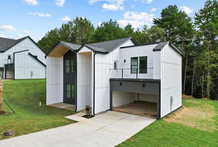 Modern house design with white and black facade, showcasing that money can't buy taste.