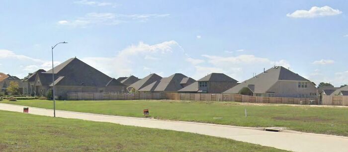 Suburban houses with similar designs, illustrating that money can't buy taste.