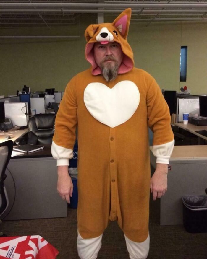 Boss in a funny dog costume standing in an office.