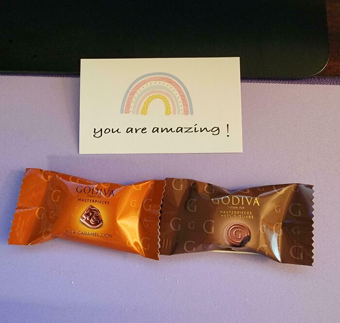 Two Godiva chocolates with a card saying "you are amazing," showcasing good-funny-bosses encouragement.