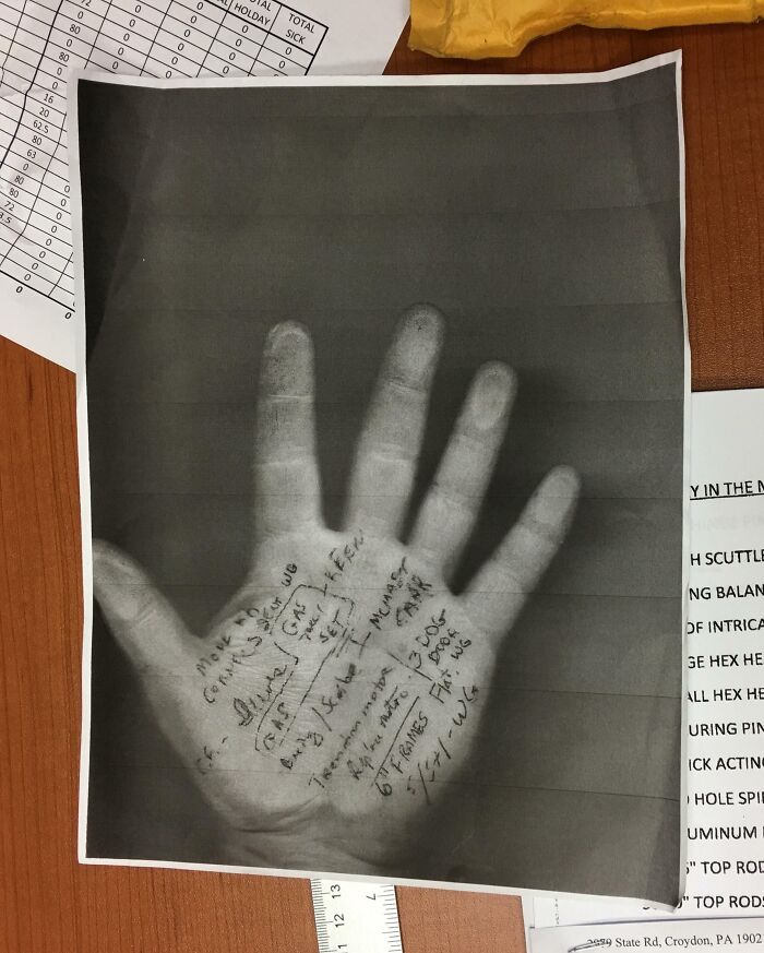 Photocopied hand with handwritten notes, surrounded by workplace documents, illustrating good-funny-bosses humor.