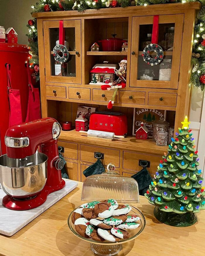 Cozy Christmas decorating ideas in a festive kitchen with cookies, red mixer, and holiday decor.