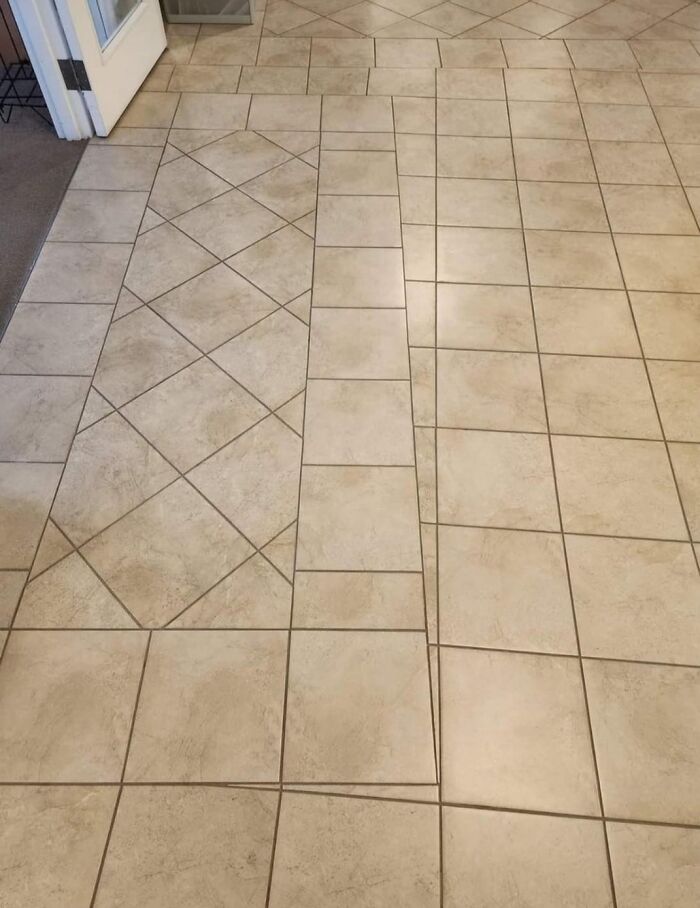 Uneven tile alignment causing a mismatched floor pattern. Funny cheap construction fail.