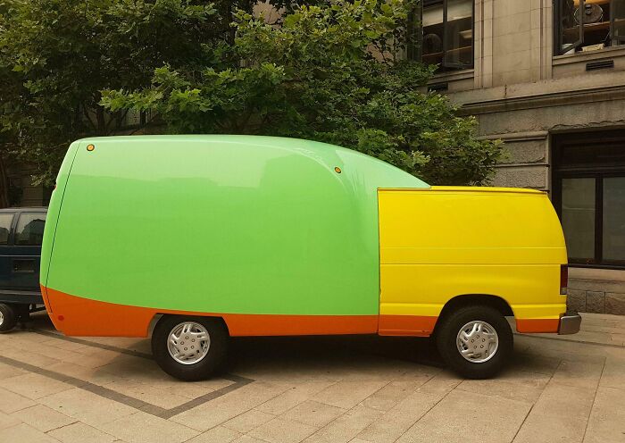 Brightly painted van with mismatched parts showcasing a car-fail.