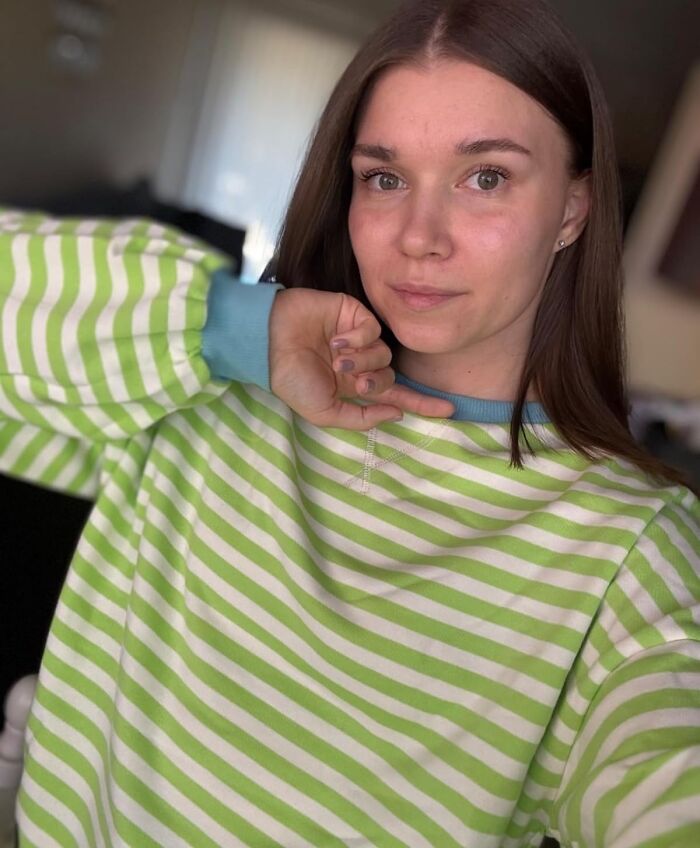 Woman in green striped sweater posing casually, perfect idea for unique gifts for women.