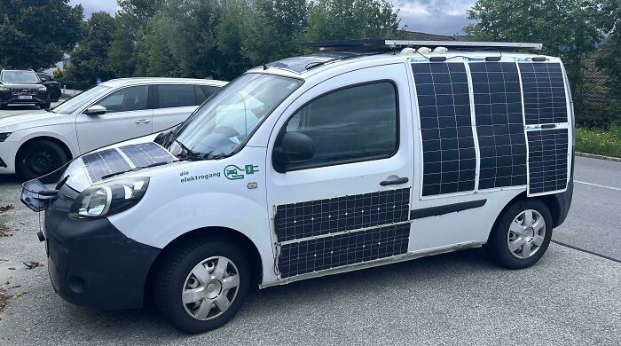 Van covered in solar panels parked on the street, illustrating a creative Car-Fails modification attempt.